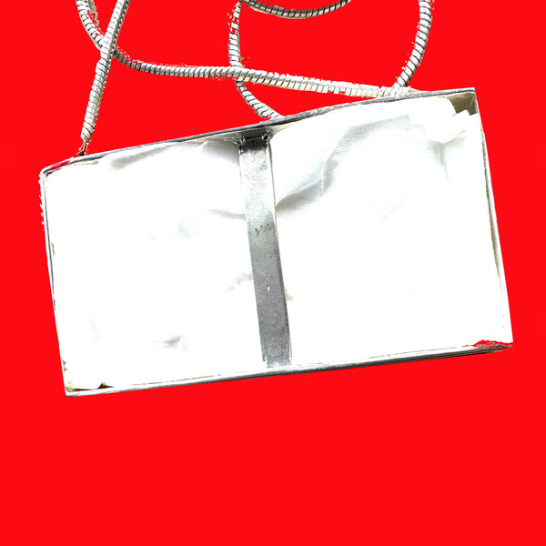Got a tissue hanging" around? You do if you are wearing this POP ART Sterling silver Hand-Enameled Baby  Blue Tissue Box necklace!  Nothing to sneeze at!  But maybe something to sneeze WITH! Stick an actual tissue inside and pop it through the opening for fun! (Comes with small pack of travel tissues!)  Baby Blue Sterling Silver Tissue Box with Aubergine letters "Tissues" is approximately 1-3/8" x 1-1/4" x 3/8" with Sterling SilverSnake Chain attached.  