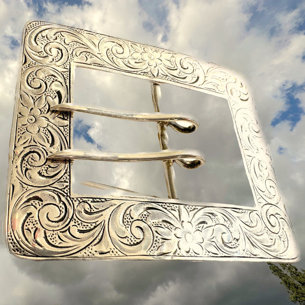 This large reproduction of a Victorian Belt buckle, with it's fine engraving and working "prong" is breathtaking whether pinned at or below the waist on a dark jacket or pair of trousers--even on a hat! In either Sterling Silver or Sterling Silver with Gold Vermeil, this Fables pieces "stands on its own". A bit of magical suspension trompe l'oeil. 2-3/4" x 2-5/8" approximately. Hand Made in the USA. Hand signed.