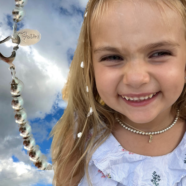 Start her out with style! Fables Sterling Silver Baby Beads, her own "Silver Pearls" with dear heart lobster signature clas These are available for this price up to 12"...add a note with your order with neck measurements of your little one and we'll add a bit of room to grow. Perfect as a newborn gift, too! Come with my branded bag in gift box, all ready to give--or receive.
