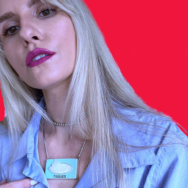 Got a tissue hanging" around? You do if you are wearing this POP ART Sterling silver Hand-Enameled Baby  Blue Tissue Box necklace!  Nothing to sneeze at!  But maybe something to sneeze WITH! Stick an actual tissue inside and pop it through the opening for fun! (Comes with small pack of travel tissues!)  Baby Blue Sterling Silver Tissue Box with Aubergine letters "Tissues" is approximately 1-3/8" x 1-1/4" x 3/8" with Sterling SilverSnake Chain attached.  