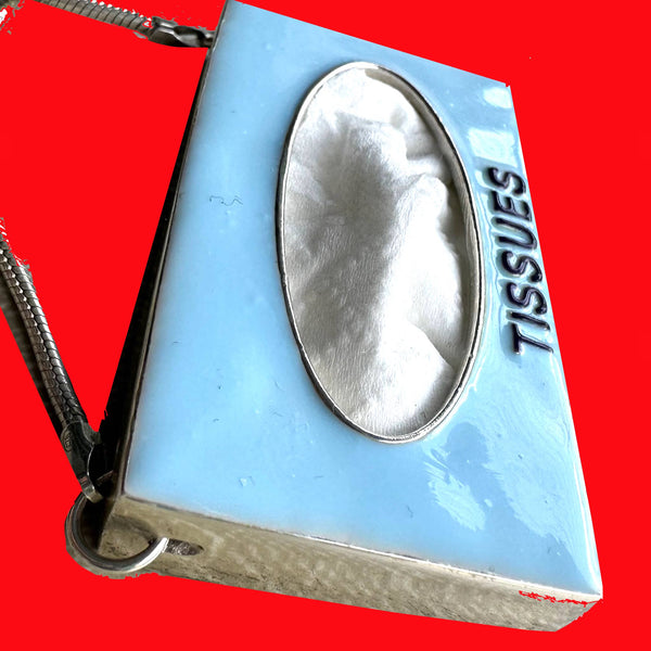 Got a tissue hanging" around? You do if you are wearing this POP ART Sterling silver Hand-Enameled Baby  Blue Tissue Box necklace!  Nothing to sneeze at!  But maybe something to sneeze WITH! Stick an actual tissue inside and pop it through the opening for fun! (Comes with small pack of travel tissues!)  Baby Blue Sterling Silver Tissue Box with Aubergine letters "Tissues" is approximately 1-3/8" x 1-1/4" x 3/8" with Sterling SilverSnake Chain attached.  