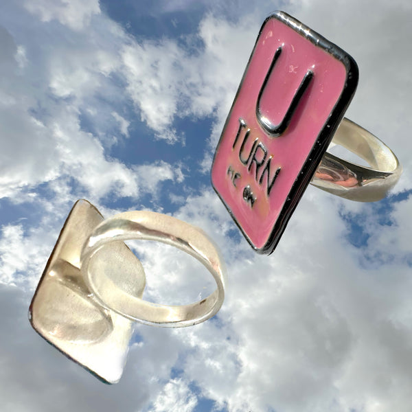 "U TURN Me On" POP ART Sterling Silverl Ring, Hand-enameled on Sterling Silver. Measures approximately 1" by 3/4". Handmade, &nbsp;Hand-Enameled and Hand-signed Here in the good ole USA! &nbsp;. Sizes 5-9 . Email me about larger sizes for an additional fee.  &nbsp;Comes in branded cotton pouch, gift-boxed &nbsp;and ready to give, or receive!  Who wouldn't want THIS Message?) &nbsp;