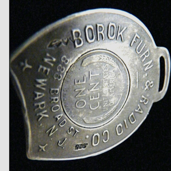   I absolutely love the fact that Borok sold a combination of furniture and radios! I'm sure it had wooden floors and probably a Chiclet machine somewhere and I feel lucky just knowing it existed.  1-3/8" x 1-6/8" approximately. Made in the USA, as always. Hand signed.  Sterling Silver Borok 1937 Lucky Penny Charm comes with black leather cord. Collect a handful of my lucky charms and stagger the length of chains, coupled with leather cords and ribbons and create your own fable!  Take a nostalgic walk with 