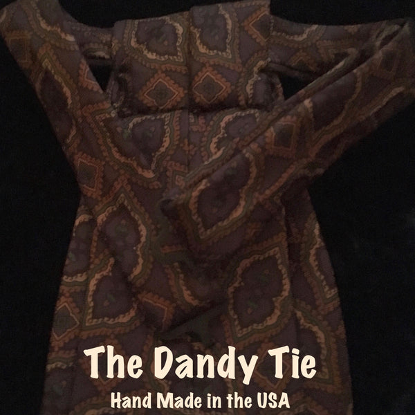 The Dandy Tie.  Each is a ONE OF A KIND and HANDMADE,by me, out of recycled neckties I handpick because of their texture or color or print. Created for men AND women, and designed to be worn for a lifetime, because of their timeless elegance, you are guaranteed to never see another like yours. Completely adjustable, the Dandy Tie is meant to be worn with or without a shirt. Use your own imagination!