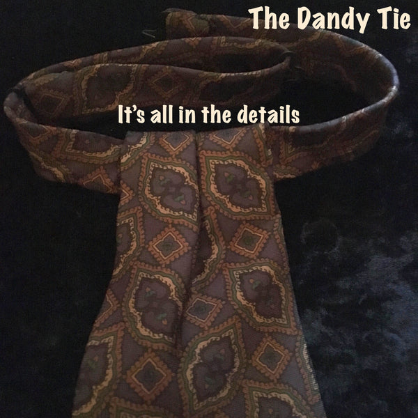 The Dandy Tie.  Each is a ONE OF A KIND and HANDMADE,by me, out of recycled neckties I handpick because of their texture or color or print. Created for men AND women, and designed to be worn for a lifetime, because of their timeless elegance, you are guaranteed to never see another like yours. Completely adjustable, the Dandy Tie is meant to be worn with or without a shirt. Use your own imagination!