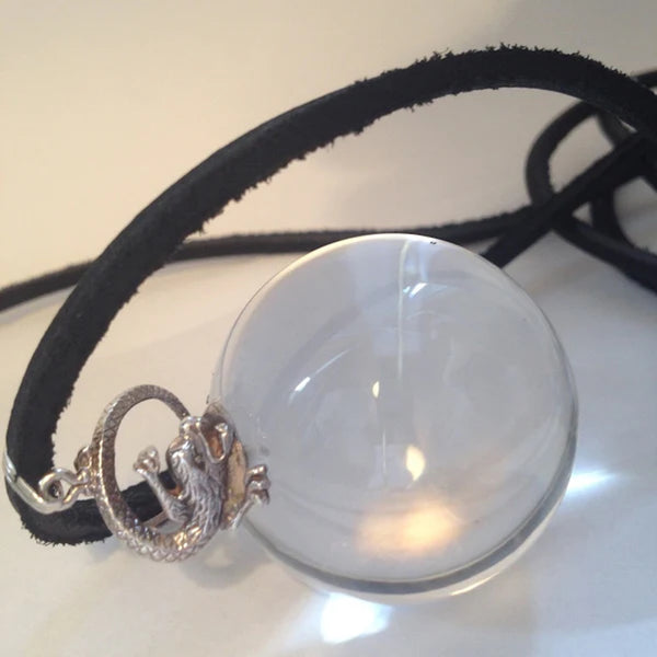 Lucite "Crystal Ball" &nbsp;and Sterling Silver Dragon Orb. Dragon-5/8". Orb-1-3/8". Crystal Ball with Sterling Silver dragon sitting on top of the world! Fables faux "Mystical Jewelry". If you are looking for a fun way to have a crystal ball... Plexiglass "crystal" Ball suspended by a Sterling Silver Dragon. Hand Made in America. Hand Signed. Comes with long leather cord or Vintage looking ribbon.