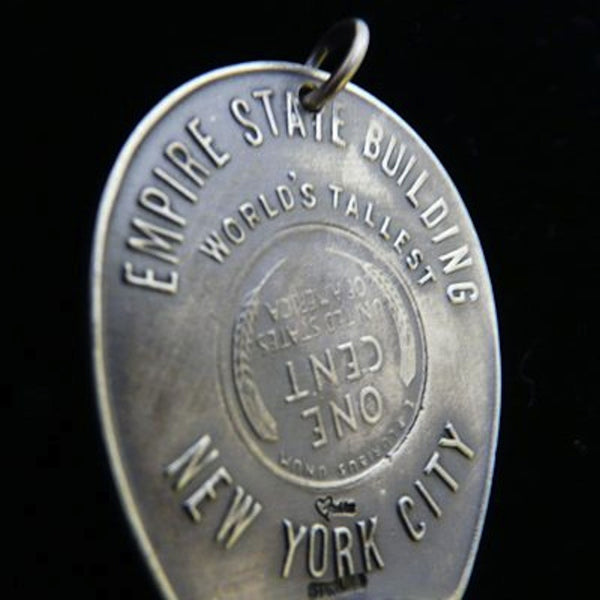 Who knows that this "Lucky Penny" didn't have something to do with the end of WWII? (Okay, technically, it was already over by 1946, but I don't have to be a jewelry designer AND a historian, do I?) A replica of a souvenir from this mere "baby" of a building, The Empire State Building--fifteen years old at the time and the worlds' tallest skyscraper! And a personal favorite of mine!  1-1/2" x 1-1/4"Approximately. Hand made in America. Hand signed.  Sterling Silver 1946 Lucky Penny Charm comes with black lea