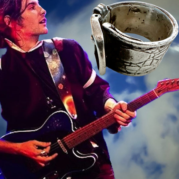 Substantial piece of pure vintage rock and roll--as seen on Zane Carney, in Avril Lavigne's "I Fell in Love with the Devil"Music Video.. Opulent,finely detailed band of timeless whimsy in Oxidized Sterling Silver Buckle Ring makes a statement alone or as part of a collection of fables...Sterling Silver distressed Crocodile textured buckle ring. Handmade in America and Hand-signed.