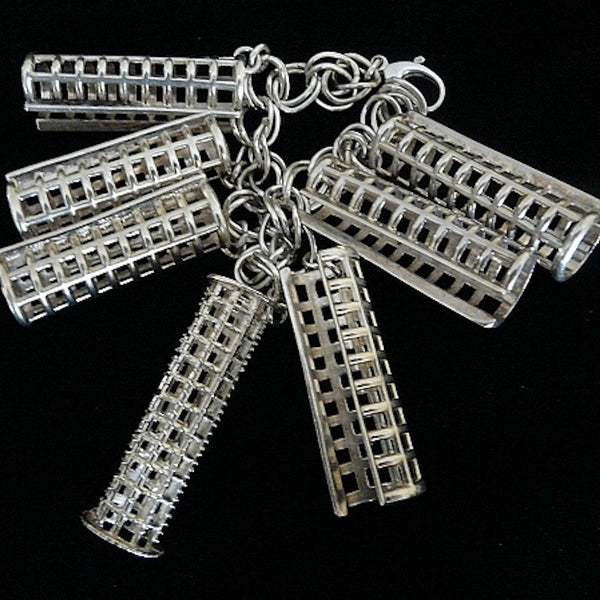 Ahhh, the price of BEAUTY past! (And one of the reasons I am known for turning items usually related to "womens' drudgery" into fashion statements--I see these things as working pieces of art in the museum of life) Simply "charming" sterling silver bracelet filled with six curler covers vying for a sole brush roller. Perfect for anyone who has hair, er... who loves and remembers brush rollers from "the day". Sterling Silver Curler and Curler Cover Charm Bracelet. Curlers-2"x5/8". Chain-7-1/2