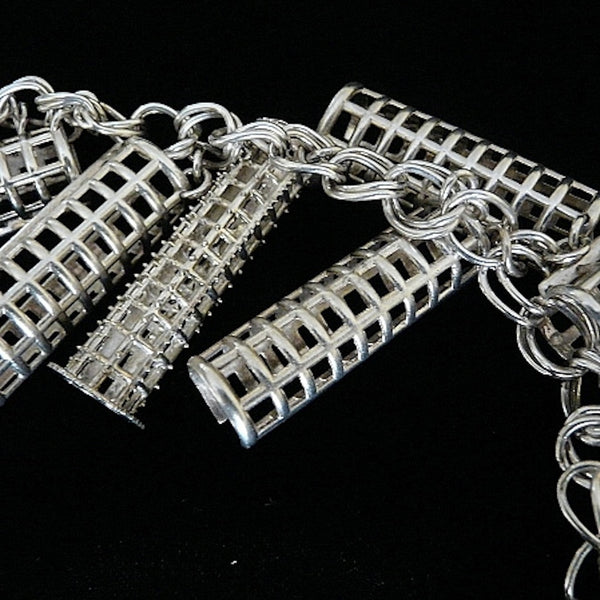 Ahhh, the price of BEAUTY past! (And one of the reasons I am known for turning items usually related to "womens' drudgery" into fashion statements--I see these things as working pieces of art in the museum of life) Simply "charming" sterling silver bracelet filled with six curler covers vying for a sole brush roller. Perfect for anyone who has hair, er... who loves and remembers brush rollers from "the day". Sterling Silver Curler and Curler Cover Charm Bracelet. Curlers-2"x5/8". Chain-7-1/2