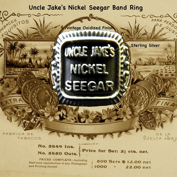Even if you are not a cigar aficionado, this vintage cigar band ring is "smoking". The first in what will be an expansive and whimsical collection,  this 3D version of an actual antique "Seegar" band--the first of its kind. Sterling Silver in my antique satin oxidized finish to bring the old cigar band to life once again!  Top 1/2" wide approximately.  Made in the USA by hand. Hand signed.  Sterling Silver Uncle Jake's Nickel Seegar Cigar Band Ring.  Be sure to check out my other two cigar band rings--Mild 
